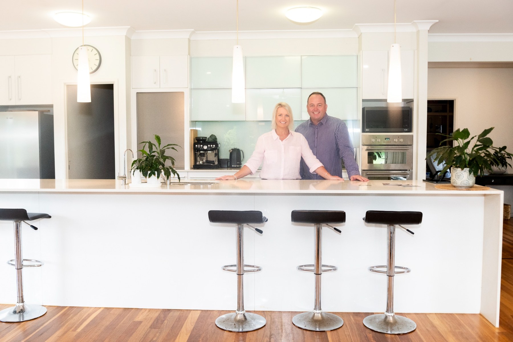 Darren and Megan together in a bright home kitchen